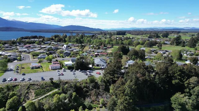 Manapouri town from a drone in New Zealand with mountains in the background