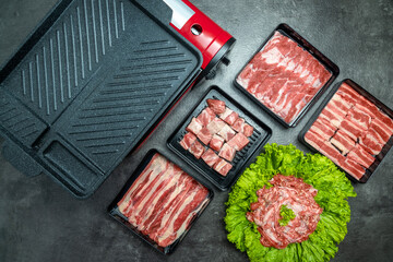 A variety of meats and vegetables are displayed on a counter