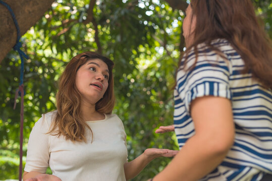 An asian woman being defiant and rude even after being caught and confronted by her friend or neighbor.