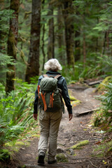 Fototapeta premium Serene mature woman enjoying autumn forest hike