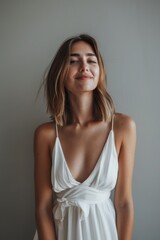Fototapeta premium photo of beautiful Caucasian model smiling looking at the camera, isolated on dark grey, clean dark grey background