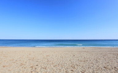 Morning view of sand and sea horizon against blue sky at Jangsa Beach of Jangsa-ri at Yeongdeok-gun, South Korea
