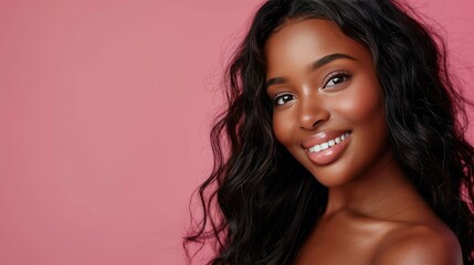 Obraz premium Stunning woman with wavy hair, bust-up image on pink studio background, confident and radiant