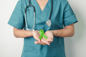 Doctor with green Ribbon for world Lymphoma Awareness September month, world Mental Health Day,...