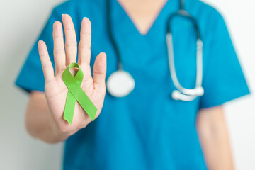 Doctor with green Ribbon for world Lymphoma Awareness September month, world Mental Health Day,...