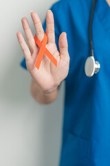 Doctor with Orange Ribbon for Leukemia, Kidney cancer day, world Multiple Sclerosis, CRPS, Self...