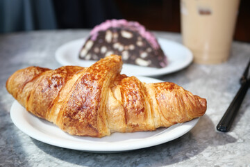 fresh baked croissant on plate with copy space 
