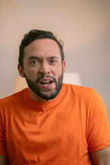 Obraz premium Hispanic man making a shocked expression on a white background
