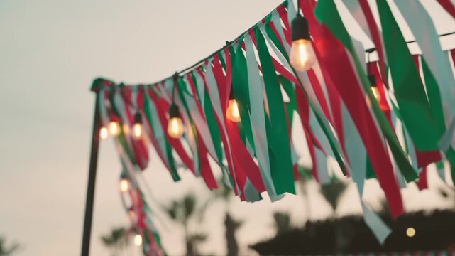 Colorful ribbons and lights hanging at dusk on a Mexican night