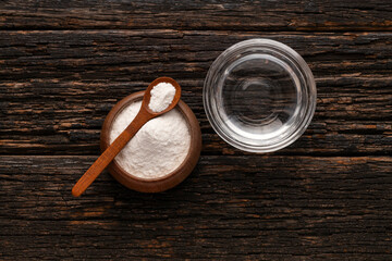 Baking soda powder in spoon and mineral water - Healthy food