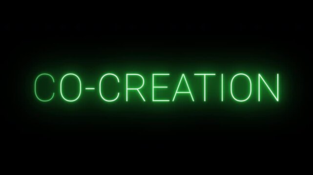 4K flickering neon green co-creation sign on black background