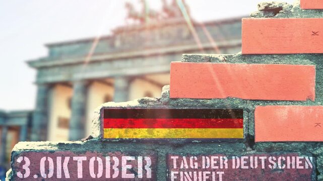 Eine Mauer in Berlin und Hinweis auf 3 Oktober Tag der deutschen Einheit