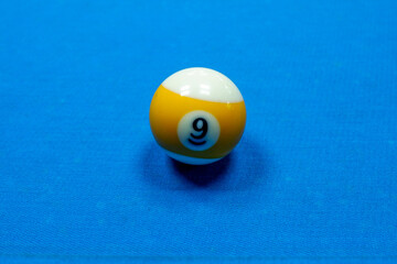 Nine billiard balls on a blue table background