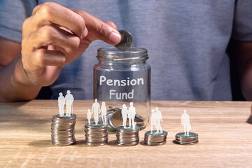 Saving money for retirement planning concept. Human life cycle on stack of coins and a glass jar to prepare a pension fund.