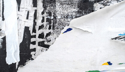 White paper poster ripped torn is glued to the wall with space for text