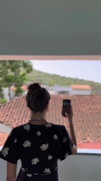 Tourist making a video of Picturesque red Rooftops in Pampatar. Vertical Video