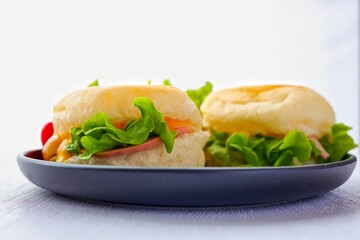 Homemade ham hamberger in black plate on white background