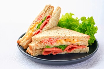 Homemade ham with sweet corn  sandwich in black plate on white background