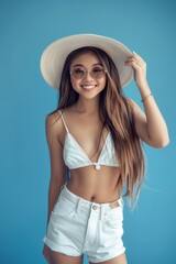 Fototapeta premium Model Photography, full body Portrait of young asian beautiful smiling female in trendy summer cloth. care free woman posing isolated in blue background