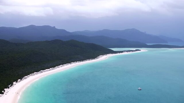 Whitehaven Beach Whitsundays Island aerial drone Airlie National Park Australia AUS QLD cloudy rainy yacht boat blue sky outer Great Barrier Reef clear blue turquoise ocean white sand upwards motion - Powered by Adobe