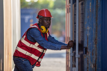 Male african american foreman opening door of container. engineering man checking containers loading. ​Area logistics import export and shipping.