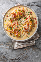 Creamy Chicken Corn and bacon closeup on the plate on the table. Vertical top view from above