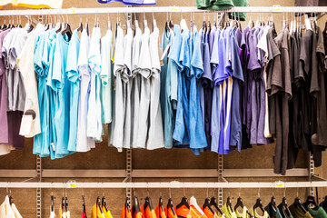 Multicolored men's sports T-shirts sweatshirts in the sports department of the supermarket. Everyday life, casual style