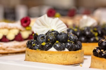 Showcase pastry shop. Cake with blueberries.