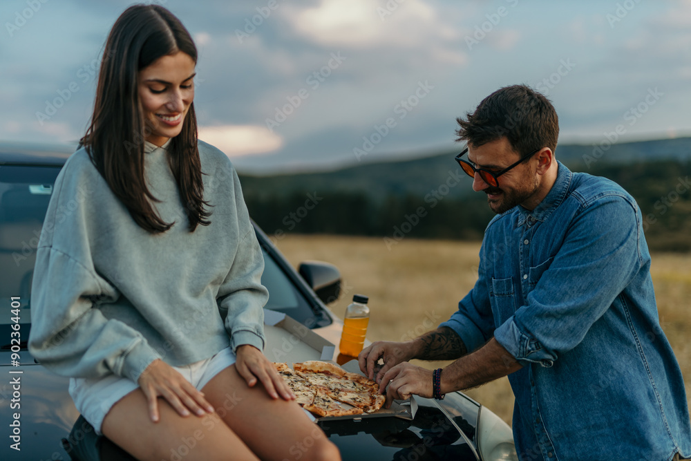 Sticker A happy woman and man are eating and enjoying the road trip concept. copy space