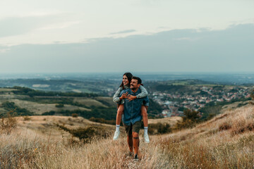 Couple having a piggyback ride, happy and smile hug in nature on a travel, adventure and road trip outdoor