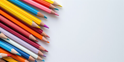 Obraz premium Professional Workspace: Colorful Pencils and Pens Dispersed on a Clean White Desk Surface, Perfect for Business and Advertising Use