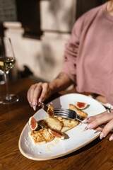 cute girl is eating a delicious dish in a beautiful and cozy bar