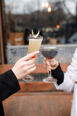 Two cute girls are drinking refreshing cocktails in a beautiful bar