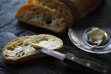 Sliced Artisan Bread with Butter on Rustic Table - Fresh Baked Loaf and Spread