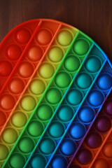 Colorful Rainbow Pop It Toy on Wooden Table - Stress Relief and Sensory Play