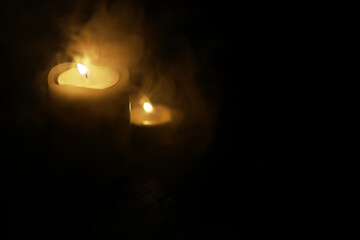 Dimly Lit Candle Surrounded by Soft Smoke in Dark Ambiance for Calm and Serenity