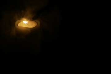 Solitary Candlelight Illuminating Darkness - Symbolic Glow in Shadowy Surroundings