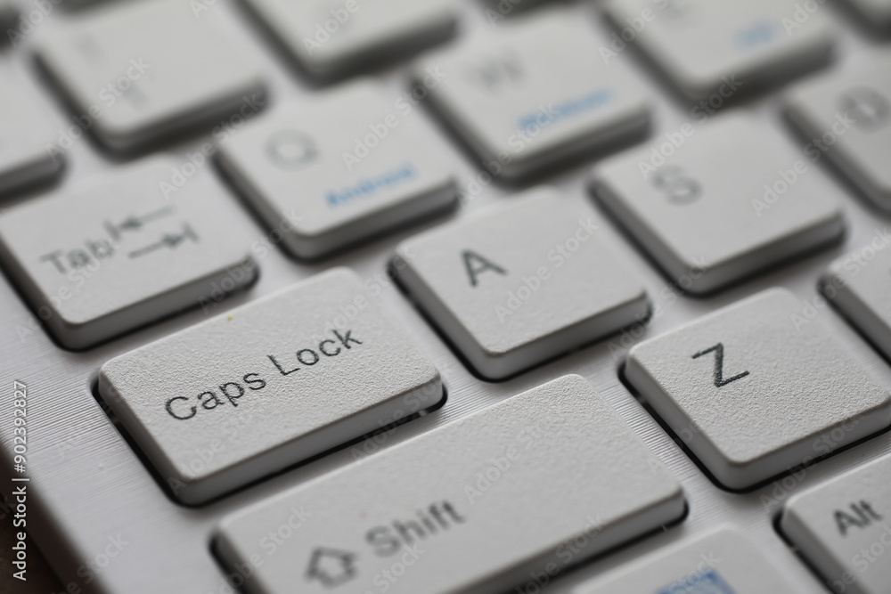 Aufkleber close-up of a white keyboard's caps lock key with alphabetic keys