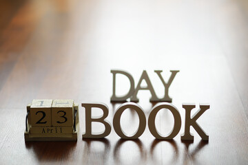 April 23 Calendar with Wooden DAY Book Letters on Wooden Table Background