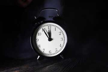 Vintage Alarm Clock at Midnight with Smoky Background - Symbolizing Time, Nostalgia, and...