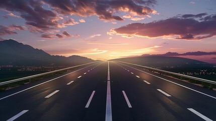 Obraz premium Empty highway stretching into the distance under a colorful sunset sky with mountains in the background.