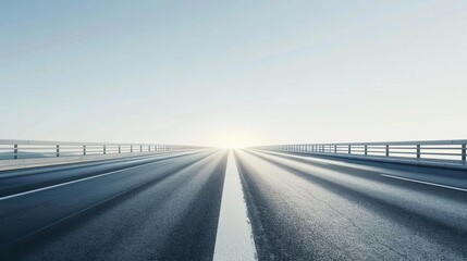 Fototapeta premium Open highway leading into the sunrise, symbolizing endless possibilities and journeys with clear skies and empty road ahead.