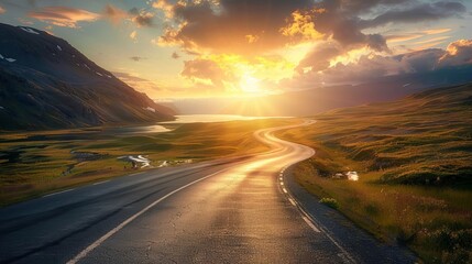 Scenic road winding through a picturesque valley at sunset, with dramatic clouds and golden sunlight illuminating the landscape.