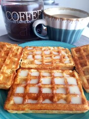 Belgian waffles with a cup of coffee on the table.