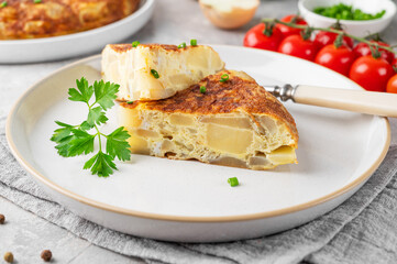 Spanish omelette tortilla with potatoes and onion on a stone background. Spanish cuisine. Top view.