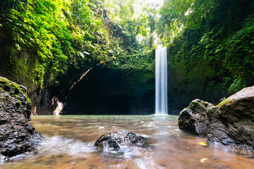Beautiful waterfall in tropical rainforest. Ideal natural environment for a travel adventure. Tibumana waterfall, Ubud, Bali, Indonesia.