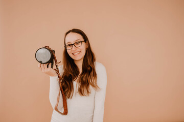 Smiling Hispanic female photographer holding camera