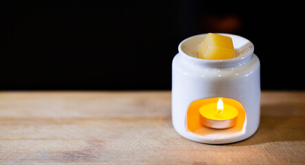 Aroma lamp with candle
 on a black background
