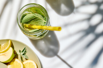 Detox drink. Infused water with pear, lime and sage. Refreshing summer homemade cocktail. Fresh healthy cold beverage.