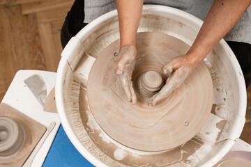 Forming the proper size and shape of pottery with increasing speed of a pottery wheel. Making a bowl on a pottery wheel with your own hands.